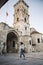 Woman in front of ancient tower of St.Lazarus church in Larnaca