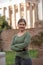 Woman in front of antique romanian sculpture