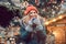 Woman in front of Christmas tree on winter market drinking hot wine