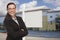 Woman In Front Commercial Building and Blank Real Estate Sign