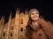 Woman in the front of Duomo in the evening looking aside