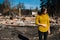 Woman in front of her burned home after fire disaster