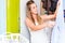 Woman in front of wardrobe in bedroom folding laundry