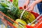Woman fruits supermarket fitness 50 plus vegetables measure basket shopping pineapple trolly red item purchase street market