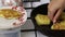 A woman is frying pancakes. Shifts the finished pancakes from the pan to the plate