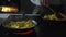 Woman frying potatoes in a pan at home