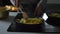 Woman frying potatoes in a pan at home