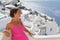 Woman with Fuchsia dress admires the Oia Scenery in Santorini