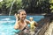 Woman with fuit drink in pool