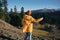 Woman full back hiker running on the mountain looking at nature happiness overlooking snowy mountains and trees in