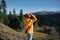 Woman full back hiker running on the mountain looking at nature happiness overlooking snowy mountains and trees in