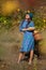 Woman with full basket colecting fruits at plantation of quinces frees