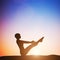 Woman in full boat yoga meditating at sunset. Zen