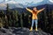 Woman in full height smile with teeth happiness hiker in yellow raincoat jumping up with his hands up on the mountain