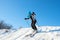 Woman in funny cap skiing on background of blue sky