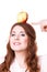 Woman funny girl holds on head apple fruit