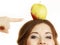 Woman funny girl holds on head apple fruit