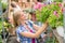 Woman at garden centre shopping for flowers