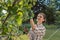 Woman in garden checking fruit tree