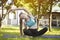 Woman in the garden practices yoga. Summer morning.