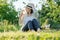 Woman gardener in hat sitting with homemade natural drink mint strawberries