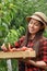 Woman gardener picking peaches