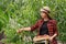 Woman gardener picking peaches