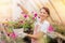 Woman gardener removes weeds from flower pots in greenhouse. Business shop plant nursery