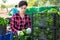 Woman gardener stacking crates with pepper