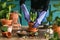 Woman gardener transplanting plants in ceramic pots on an old wooden table during the spring time.