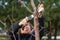 Woman gardener using garden saw on to cut dry tree branches. Spring pruning of trees and bushes in garden