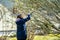 Woman gardener using pruning shears on to cut dry tree branches. Spring pruning of trees and bushes in garden