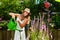 Woman gardener watering flowers in garden