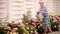 Woman gardener waters flowers with watering can. Woman watering flowers in a beautiful flower garden. Happy and smiling