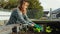 Woman gardening outside in the sun planting lettuce in her raised garden beds