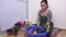 Woman with gardening shears cutting roses in bowl of water