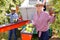 Woman gathering apples using sorting harvesting machine