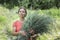 Woman is gathering healing plants and herbs Forest on background