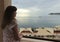 A Woman Gazes Down from Her Seaside Resort Balcony