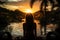 Woman gazing at phuket sunset from the pool, summer landscape image