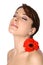 Woman with gerbera on shoulder