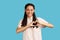 Woman gesture heart over chest, expresses love, says be my valenetine, smiles positively.