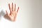 Woman gesturing a hand showing five fingers meaning stop and warning to do not do something