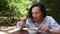 Woman gets acquainted with national Ukrainian cuisine, eats beet soup- Borscht