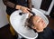 Woman Getting Hair Washed In Salon