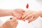 Woman getting nail manicure. Manicurist applying red nail polish