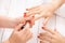 Woman getting nail manicure. Manicurist applying red nail polish to customer