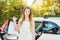 Woman getting out of Taxi car carrying shopping bags