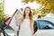 Woman getting out of Taxi car carrying shopping bags