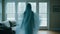 a woman in a ghostly white dress is standing in front of a window